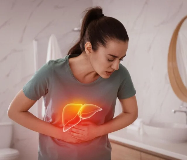 A woman holding her stomach with a glowing liver illustration over her abdomen.